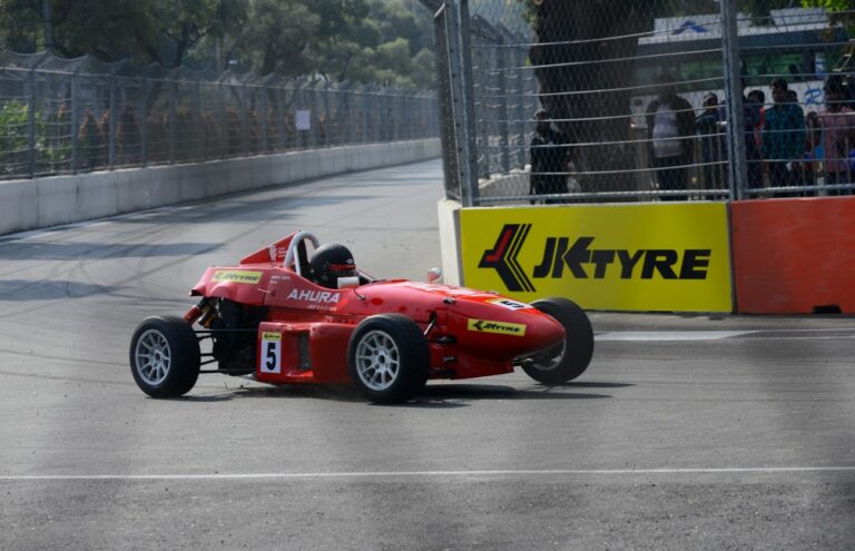 An Ahura Racing car zooming past at the Hyderabad Street Circuit during Round 3 of JKNRC