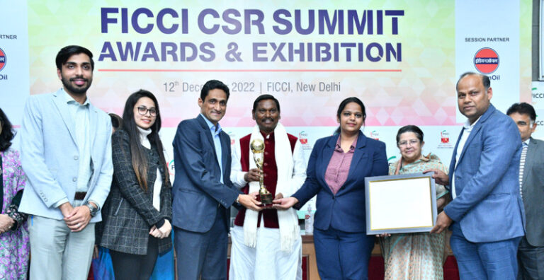Schneider Electric accepting the trophy at the 20th FICCI CSR Awards Ceremony