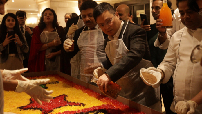 Chefs at Ashok Hotel join hands with home bakers for the Christmas cake mixing