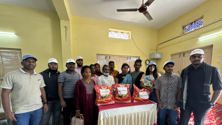 Movate volunteers & a group of trans women with ration kits distributed at CBM India's eye screening camp